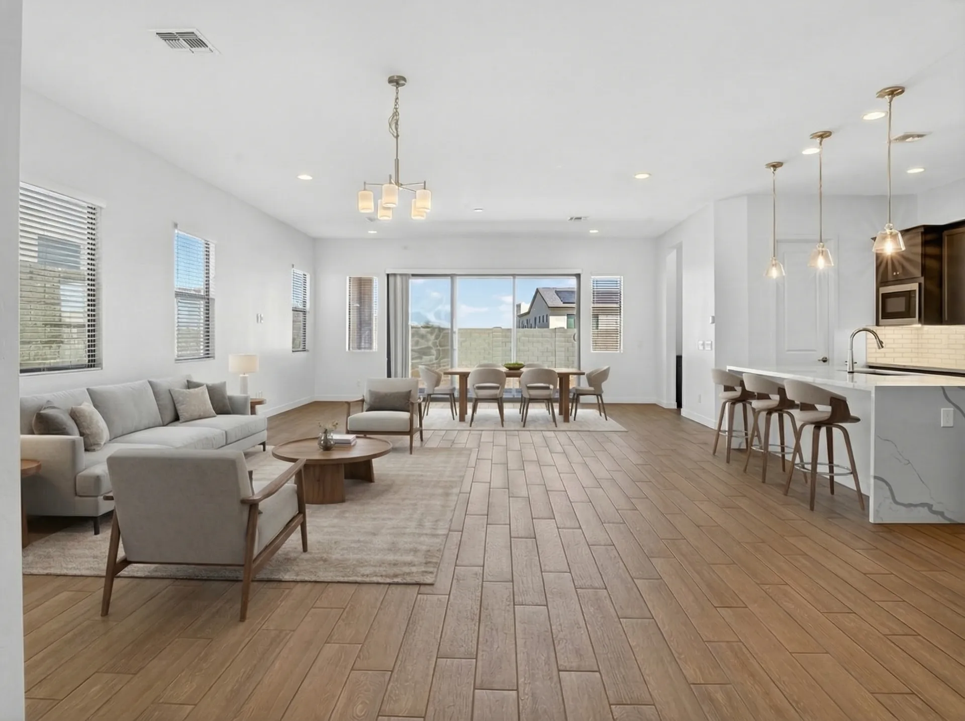 Empty great room vs virtually staged great room with kitchen and dining area — after